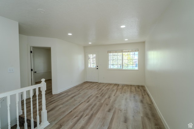 2976 E Saddle Rock Rd, Eagle Mountain, UT 84005 - empty room featuring recessed lighting, light wood-style flooring, and baseboards