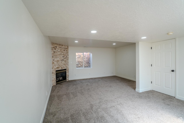 2976 E Saddle Rock Rd, Eagle Mountain, UT 84005 - unfurnished living room featuring baseboards, carpet flooring, a textured ceiling, and a fireplace