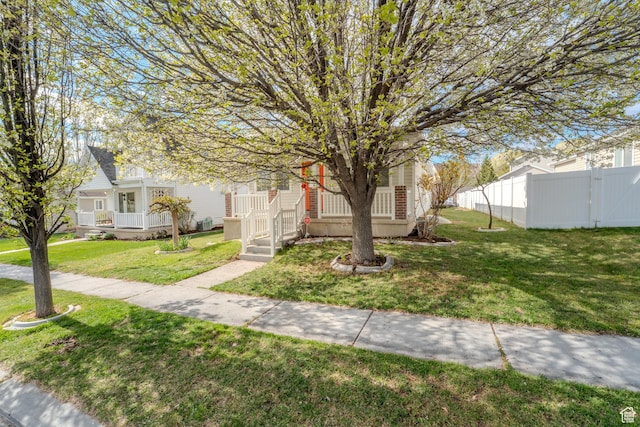 2976 E Saddle Rock Rd, Eagle Mountain, UT 84005 - view of front of property featuring fence, covered porch, and a front yard