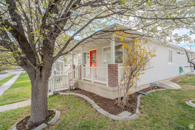 2976 E Saddle Rock Rd, Eagle Mountain, UT 84005 - view of side of home featuring brick siding and a lawn