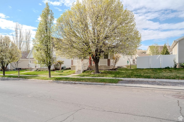 2976 E Saddle Rock Rd, Eagle Mountain, UT 84005 - view of property hidden behind natural elements featuring a residential view, a front yard, and fence