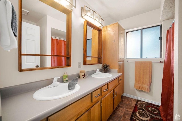 835 E Mountain View Dr, Pine Valley, UT 84781 - bathroom featuring baseboards, a sink, double vanity, and stone finish flooring