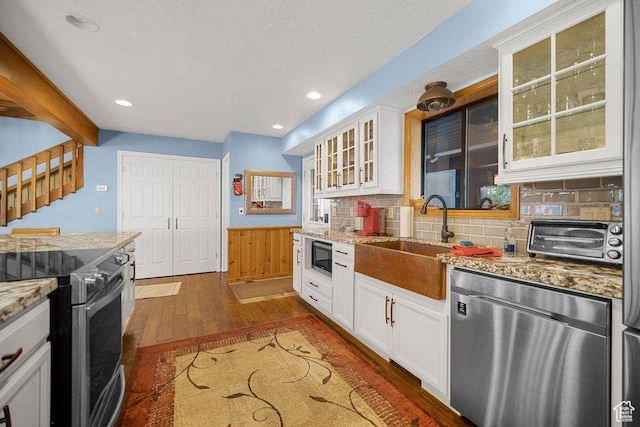 835 E Mountain View Dr, Pine Valley, UT 84781 - kitchen with white cabinets, dark wood finished floors, stainless steel appliances, a sink, and light stone countertops
