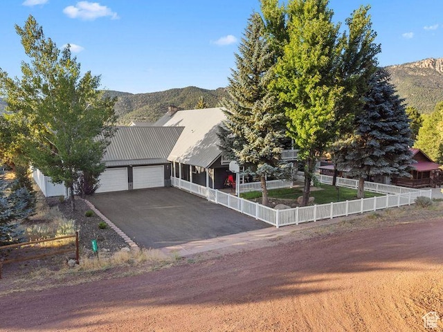 835 E Mountain View Dr, Pine Valley, UT 84781 - view of front of house featuring driveway, fence private yard, a mountain view, and a garage