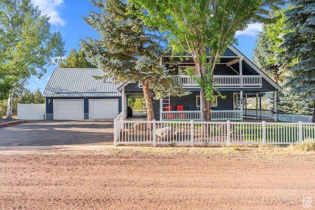835 E Mountain View Dr, Pine Valley, UT 84781 - view of front of property featuring fence private yard, an attached garage, a porch, and aphalt driveway