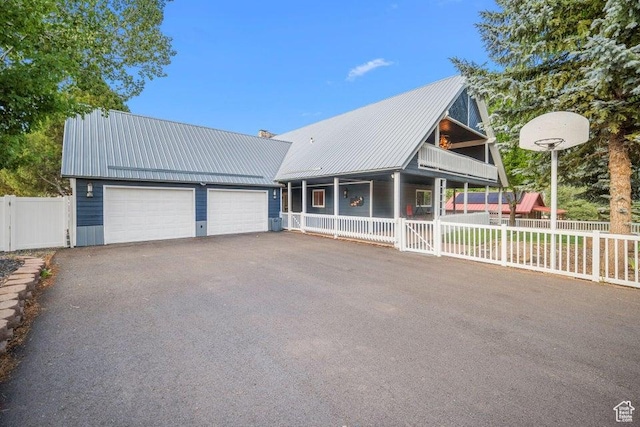 835 E Mountain View Dr, Pine Valley, UT 84781 - view of front facade with a chimney, covered porch, a playground, metal roof, and fence