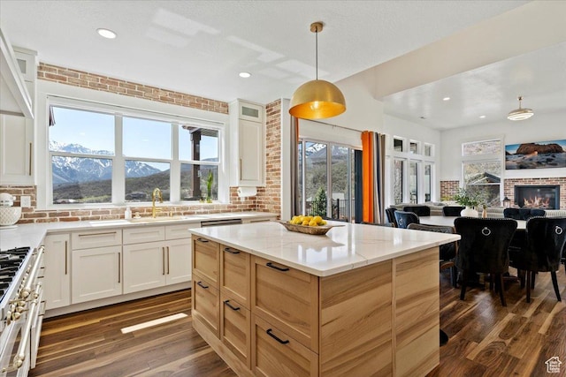 5651 W Meadow Cir, Mountain Green, UT 84050 - kitchen with open floor plan, range with gas stovetop, light stone countertops, and dark wood-style floors