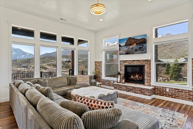 5651 W Meadow Cir, Mountain Green, UT 84050 - living area with dark wood-style floors, baseboards, recessed lighting, visible vents, and a fireplace