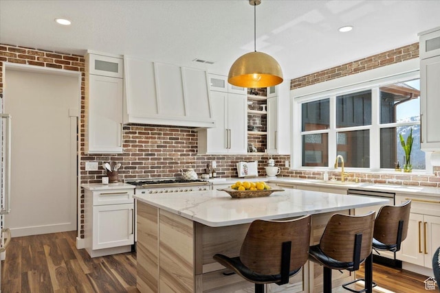5651 W Meadow Cir, Mountain Green, UT 84050 - kitchen with tasteful backsplash, custom range hood, stovetop, a kitchen island, and dark wood-type flooring