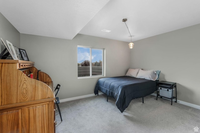 carpeted bedroom with visible vents and baseboards