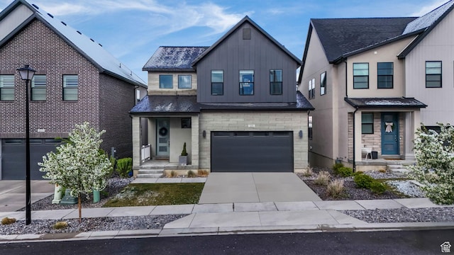 view of front of property featuring an attached garage, driveway, and board and batten siding