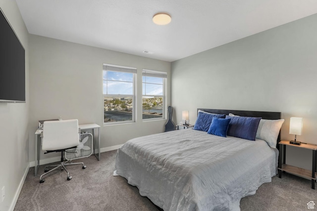 carpeted bedroom with baseboards and visible vents