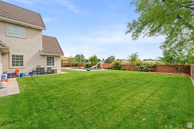 view of yard featuring a fenced backyard, a fenced in pool, and a patio