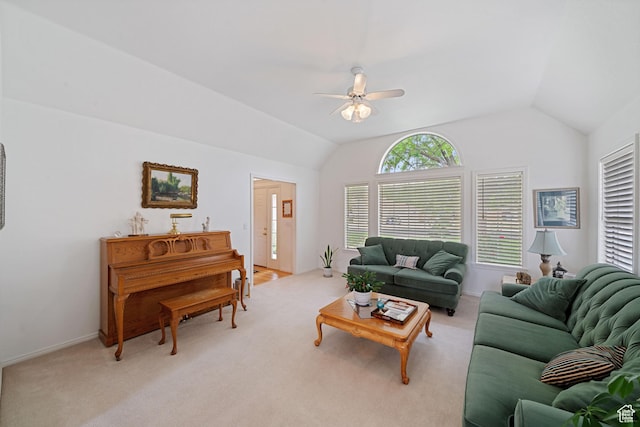 living area with lofted ceiling, light carpet, baseboards, and ceiling fan