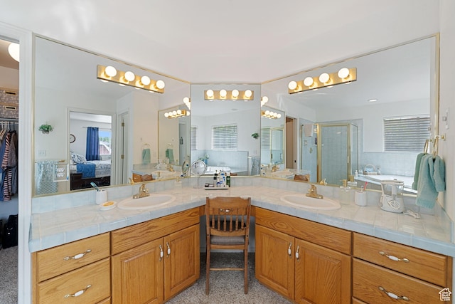 ensuite bathroom featuring a bath, connected bathroom, vanity, and a stall shower