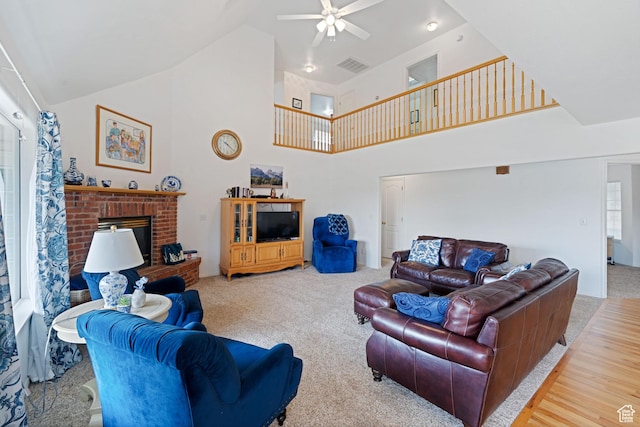 living room with visible vents, high vaulted ceiling, a ceiling fan, a fireplace, and carpet floors