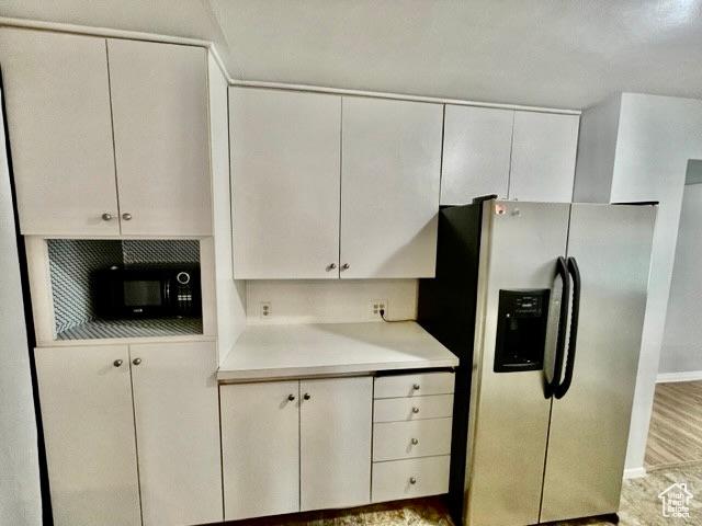 993 E 200 N, Provo, UT 84606 - kitchen featuring black microwave, light countertops, baseboards, white cabinets, and stainless steel refrigerator with ice dispenser