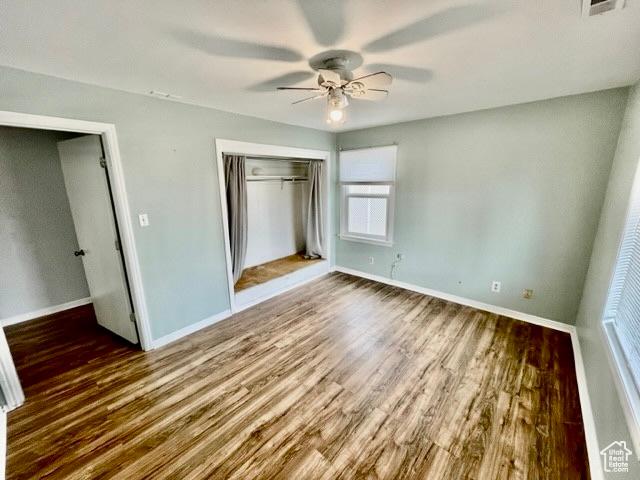 993 E 200 N, Provo, UT 84606 - unfurnished bedroom with wood finished floors, a closet, a ceiling fan, and baseboards