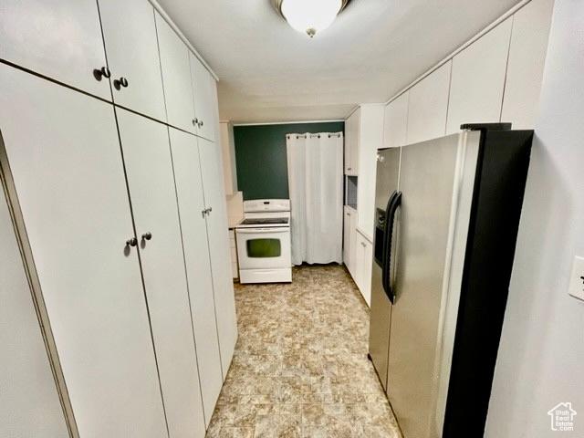 993 E 200 N, Provo, UT 84606 - kitchen with white electric stove, white cabinetry, and stainless steel fridge with ice dispenser