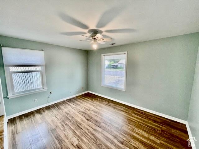993 E 200 N, Provo, UT 84606 - empty room with wood finished floors, visible vents, a ceiling fan, and baseboards