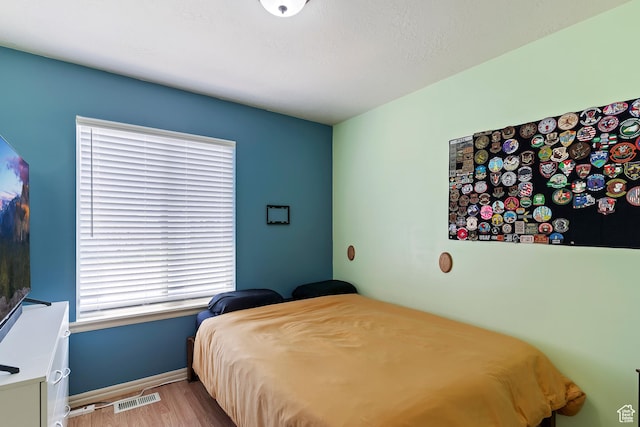 3295 S 1500 W, Perry, UT 84302 - bedroom featuring wood finished floors, visible vents, and baseboards