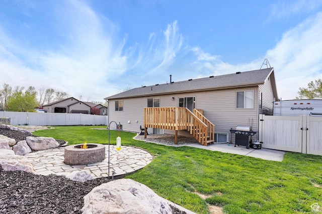 3295 S 1500 W, Perry, UT 84302 - rear view of property featuring a patio area, a deck, an outdoor fire pit, a fenced backyard, and a yard