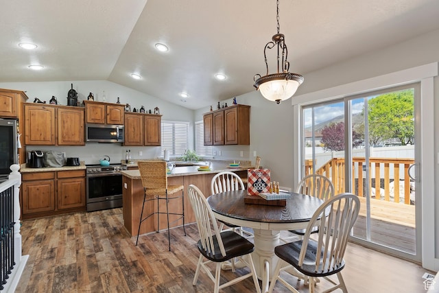 3295 S 1500 W, Perry, UT 84302 - kitchen featuring vaulted ceiling, wood finished floors, stainless steel appliances, and light countertops