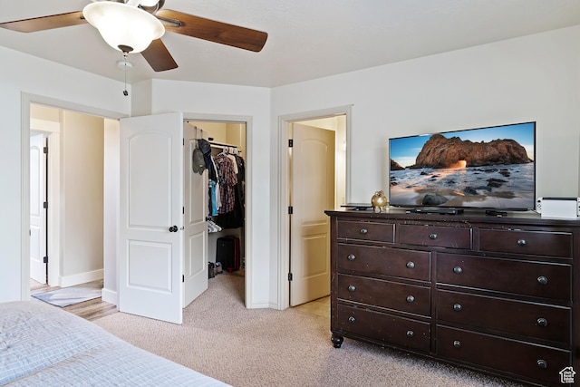 3295 S 1500 W, Perry, UT 84302 - bedroom featuring light carpet, baseboards, a ceiling fan, a closet, and a walk in closet