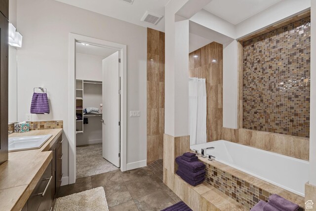 2356 S 1300 W, St George, UT 84770 - full bath with a tile shower, visible vents, tiled bath, vanity, and a walk in closet