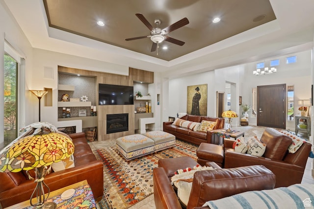 2356 S 1300 W, St George, UT 84770 - living room with recessed lighting, a tile fireplace, a raised ceiling, built in shelves, and ceiling fan with notable chandelier