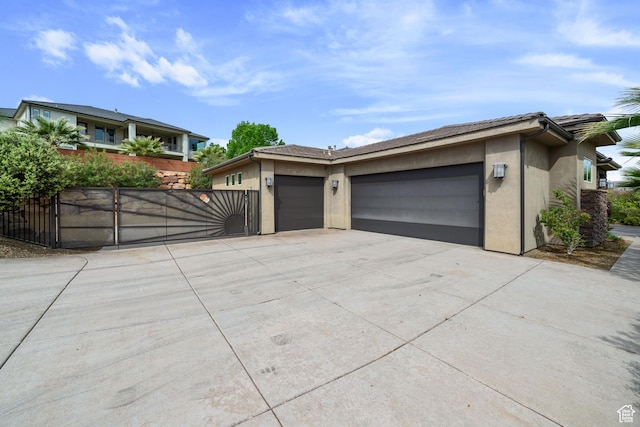 2356 S 1300 W, St George, UT 84770 - view of front of house with a garage, driveway, stucco siding, and a gate