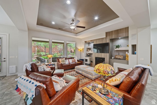 2356 S 1300 W, St George, UT 84770 - living room with a fireplace, a raised ceiling, baseboards, and ceiling fan