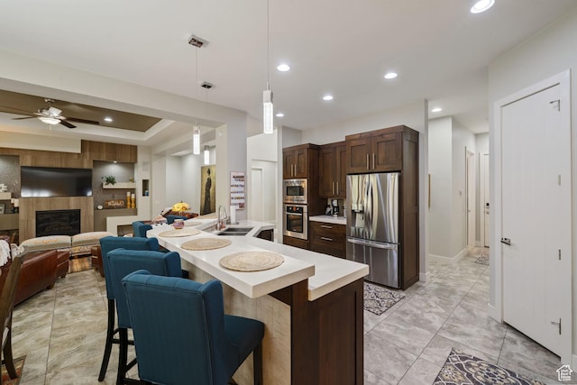 2356 S 1300 W, St George, UT 84770 - kitchen featuring a kitchen breakfast bar, light countertops, a sink, dark brown cabinetry, and appliances with stainless steel finishes