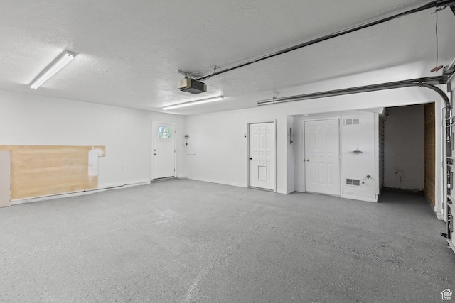 604 S Desert Willow Ln, Salina, UT 84654 - garage with visible vents and a garage door opener
