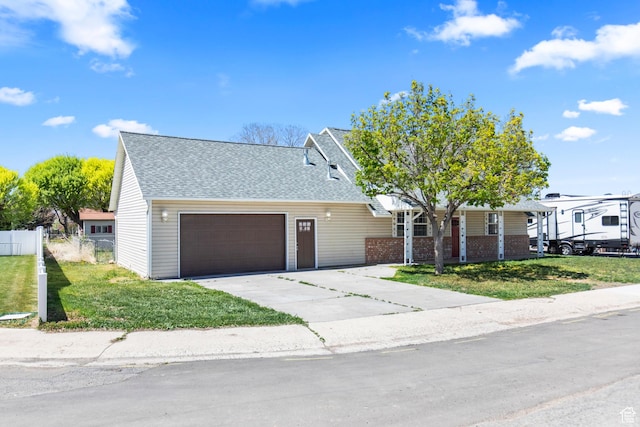 604 S Desert Willow Ln, Salina, UT 84654 - view of front of property featuring a front lawn, a garage, a shingled roof, and fence