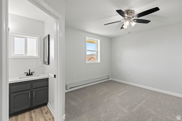 604 S Desert Willow Ln, Salina, UT 84654 - interior space with a sink, baseboard heating, ceiling fan, and baseboards