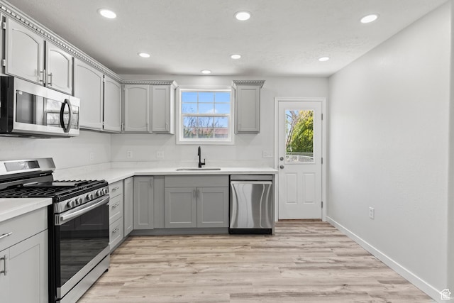604 S Desert Willow Ln, Salina, UT 84654 - kitchen featuring recessed lighting, appliances with stainless steel finishes, light countertops, a sink, and gray cabinetry