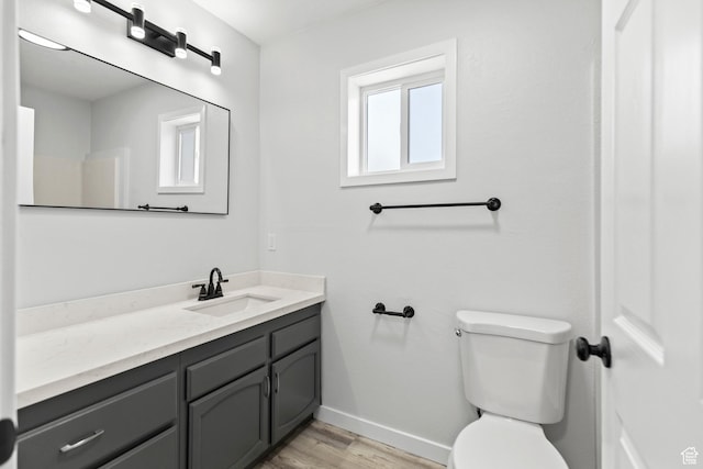 604 S Desert Willow Ln, Salina, UT 84654 - bathroom with toilet, vanity, wood finished floors, and baseboards