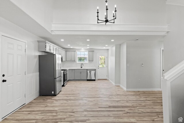 604 S Desert Willow Ln, Salina, UT 84654 - kitchen with light wood-style flooring, appliances with stainless steel finishes, light countertops, a notable chandelier, and gray cabinets