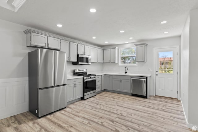 604 S Desert Willow Ln, Salina, UT 84654 - kitchen with gray cabinetry, light wood-style floors, stainless steel appliances, and a sink
