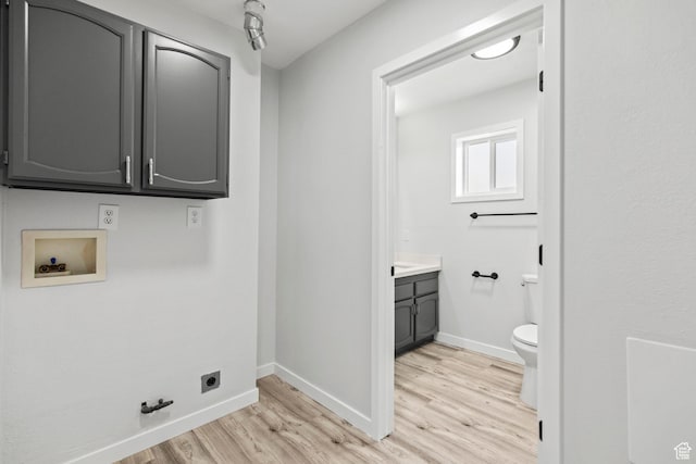 604 S Desert Willow Ln, Salina, UT 84654 - washroom featuring hookup for an electric dryer, cabinet space, light wood-style floors, hookup for a gas dryer, and washer hookup