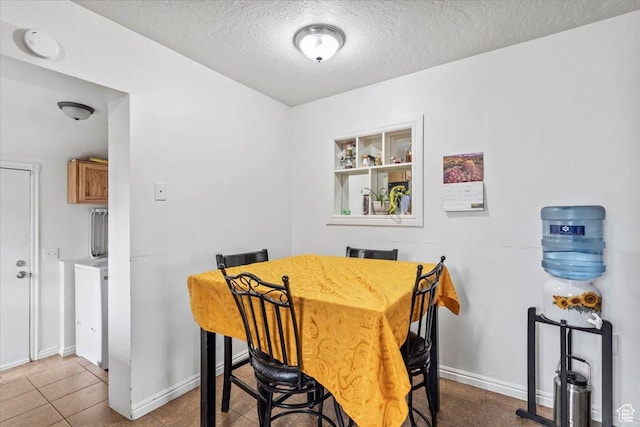 2669 S Liberty Ave E, Ogden, UT 84401 - dining space with a textured ceiling, tile patterned flooring, and baseboards