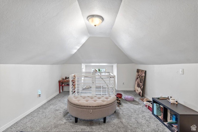 2669 S Liberty Ave E, Ogden, UT 84401 - recreation room with carpet, a textured ceiling, lofted ceiling, and baseboards