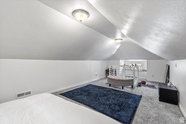 2669 S Liberty Ave E, Ogden, UT 84401 - carpeted bedroom with a textured ceiling, vaulted ceiling, visible vents, and baseboards