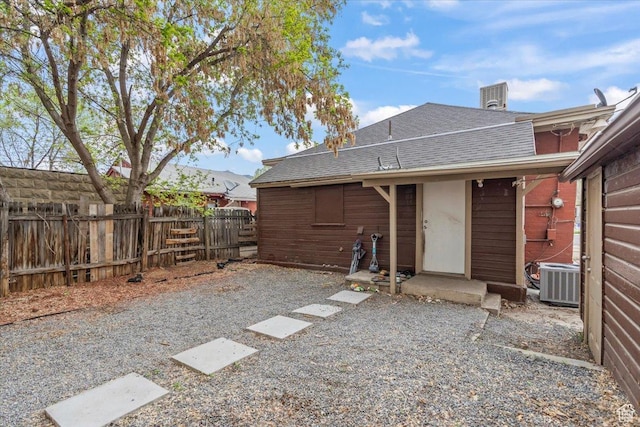 2669 S Liberty Ave E, Ogden, UT 84401 - rear view of house with fence, a shingled roof, and central AC