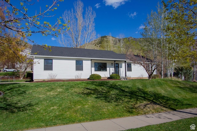 single story home featuring a front lawn
