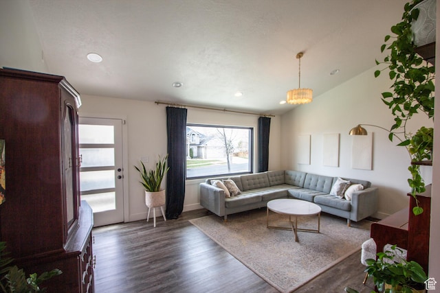 64 Winding Way, Logan, UT 84321 - living area with recessed lighting, lofted ceiling, dark wood-type flooring, baseboards, and a notable chandelier