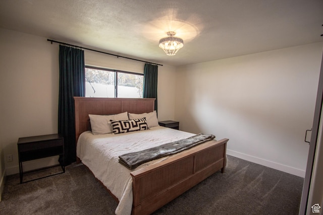 64 Winding Way, Logan, UT 84321 - bedroom with baseboards, dark carpet, and a notable chandelier