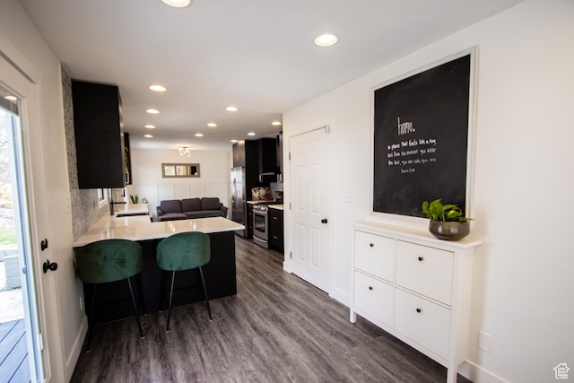 64 Winding Way, Logan, UT 84321 - kitchen with appliances with stainless steel finishes, dark cabinetry, light countertops, and recessed lighting