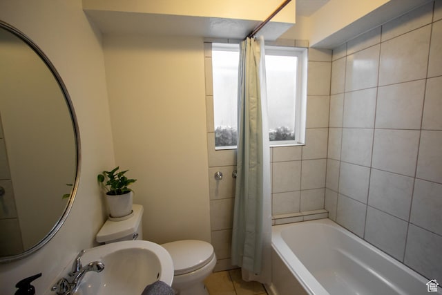64 Winding Way, Logan, UT 84321 - full bathroom featuring tile patterned flooring, toilet, shower / tub combo with curtain, and a sink